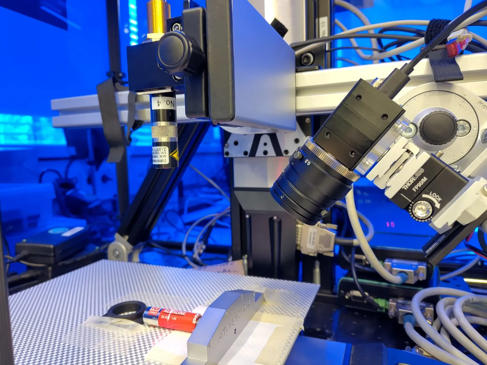 Close-up of the line-laser projector and NANO prototype camera mounted above the test object.
