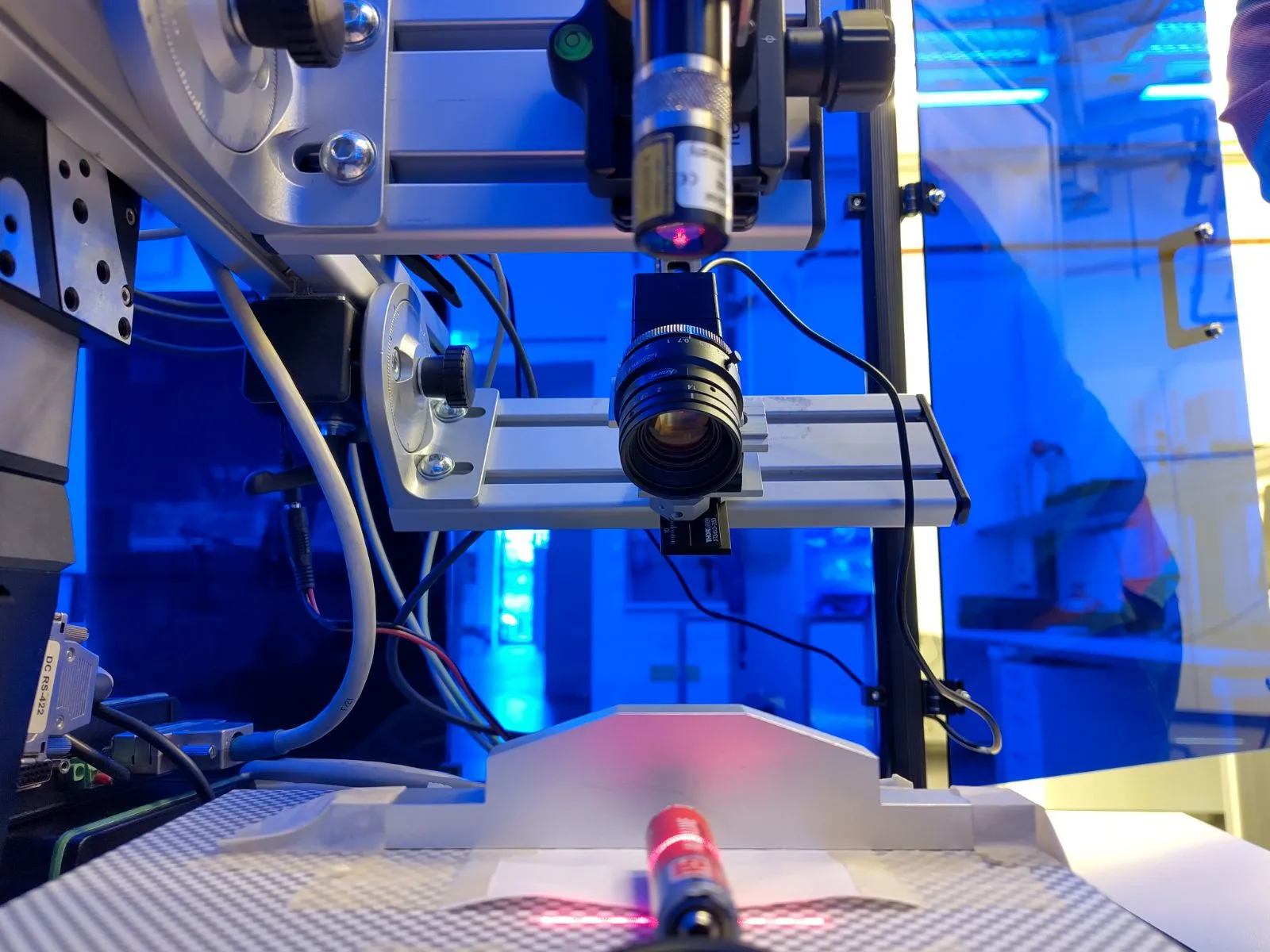 NANO prototype and line-laser projector on an optical rail, aimed down at a test object on an optical bench.