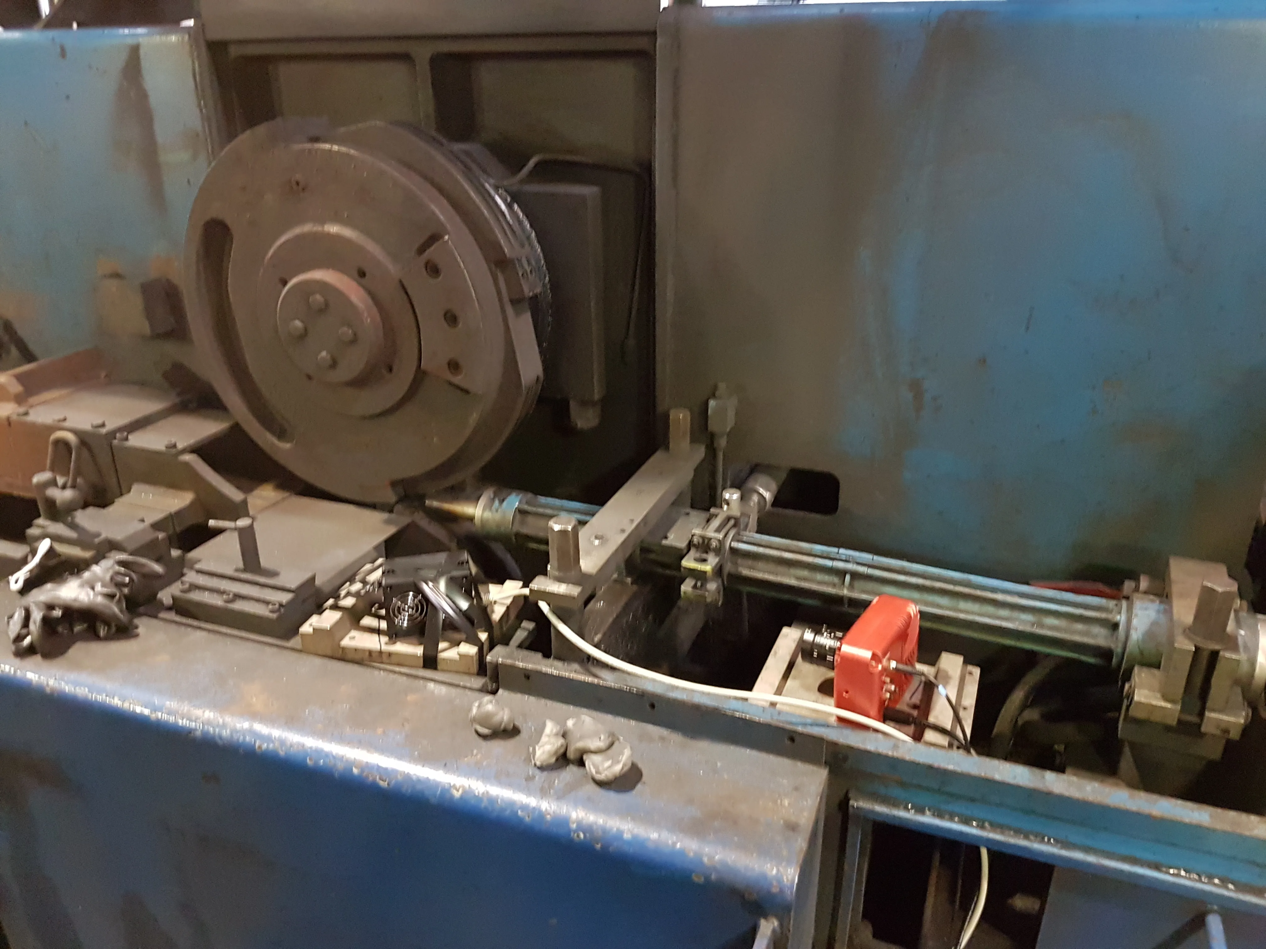 A red HSCAM camera mounted beside a rolling-mill shear, next to the cutting disc and the wire guide tube.